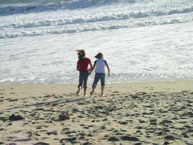 two girls walking on the beach